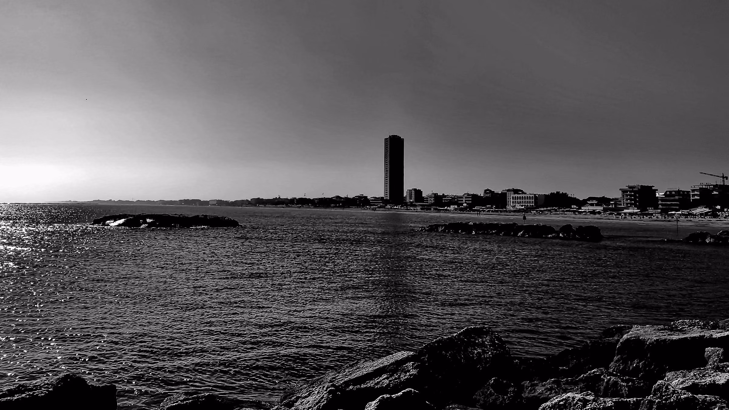 The sea and Cesenatico's seafront at dawn, seen from rocks at the Porto Canale.