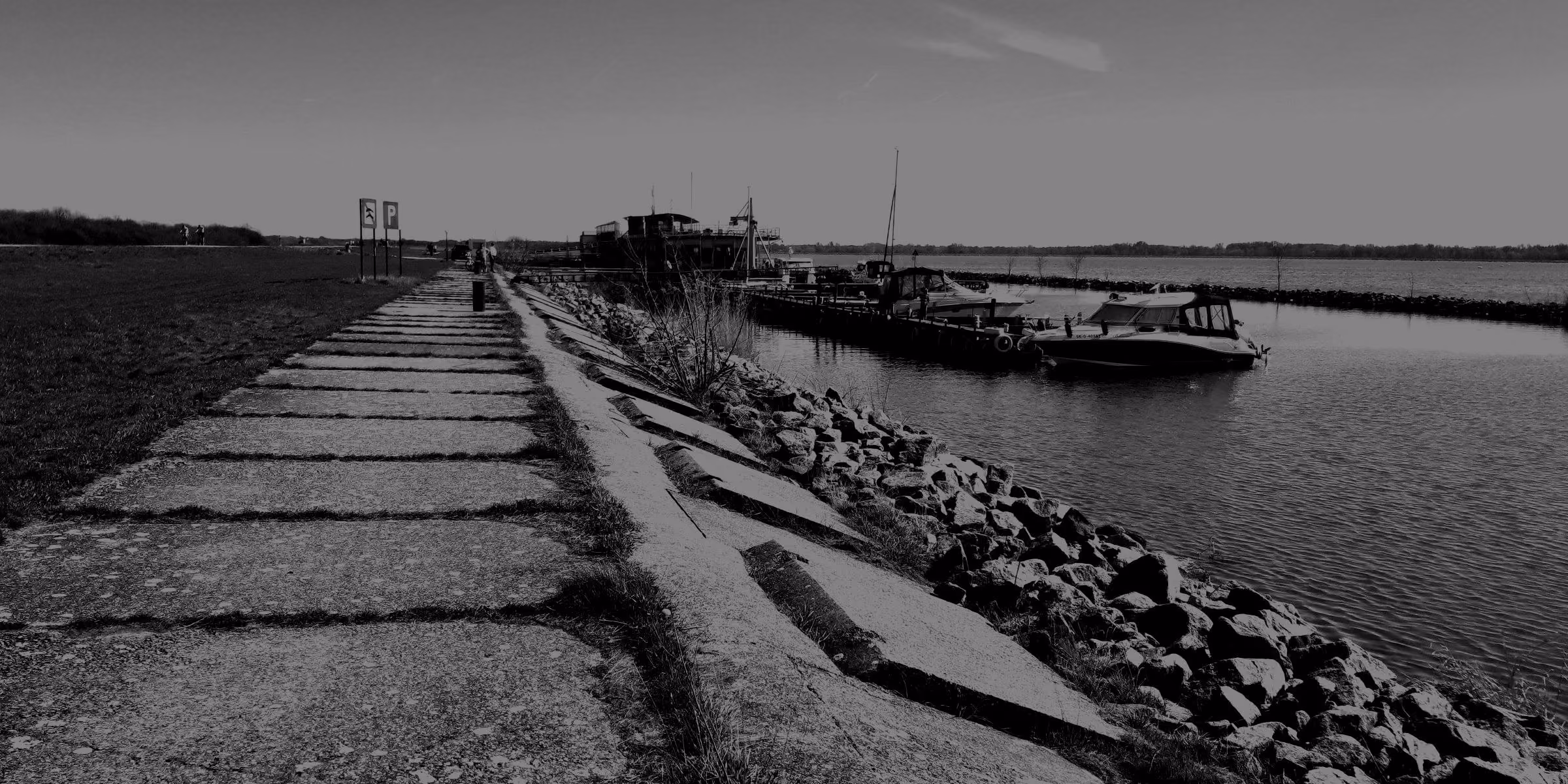 The Danube beside a stone dike and moored boats at Čilistov, Šamorín.