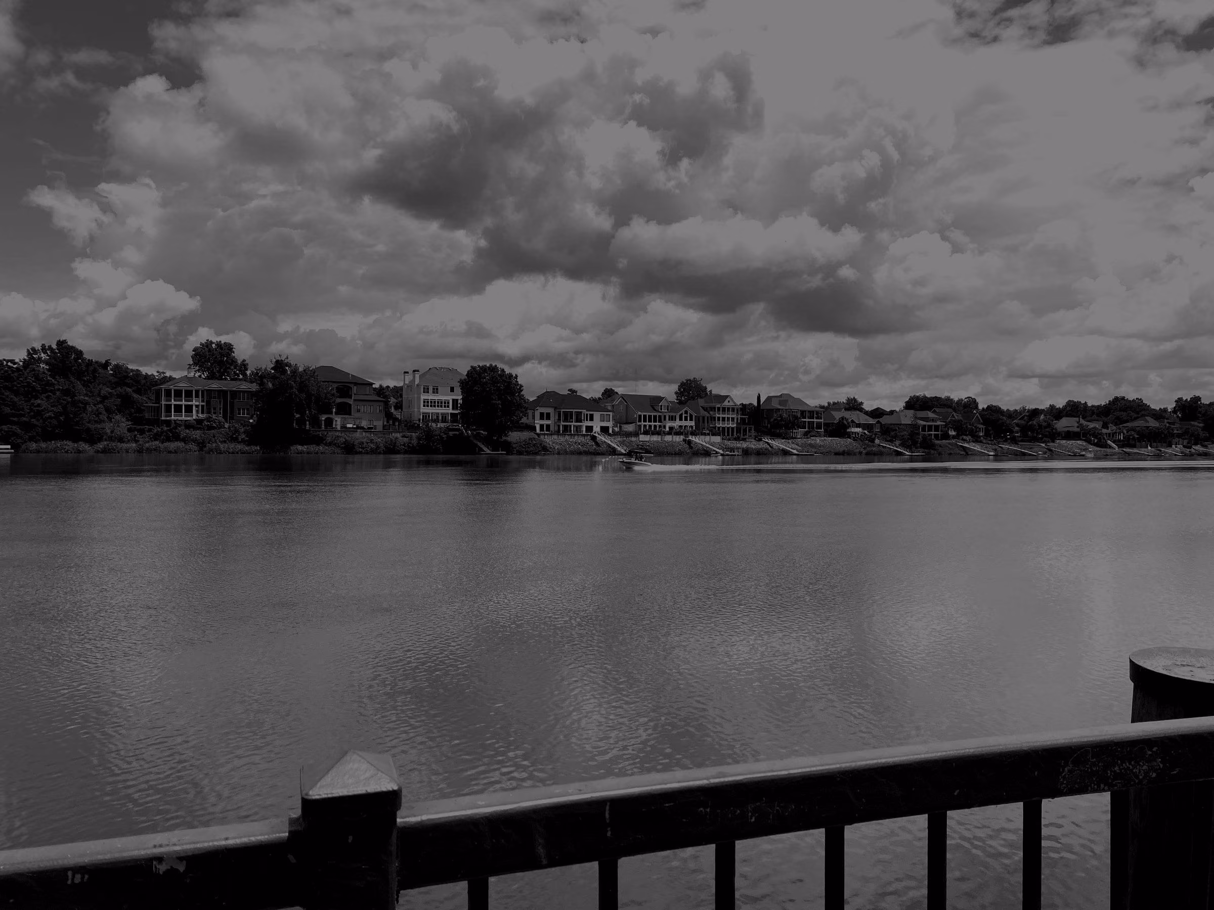 The Savannah River at Augusta under a cloudy summer sky, seen from the Riverwalk.