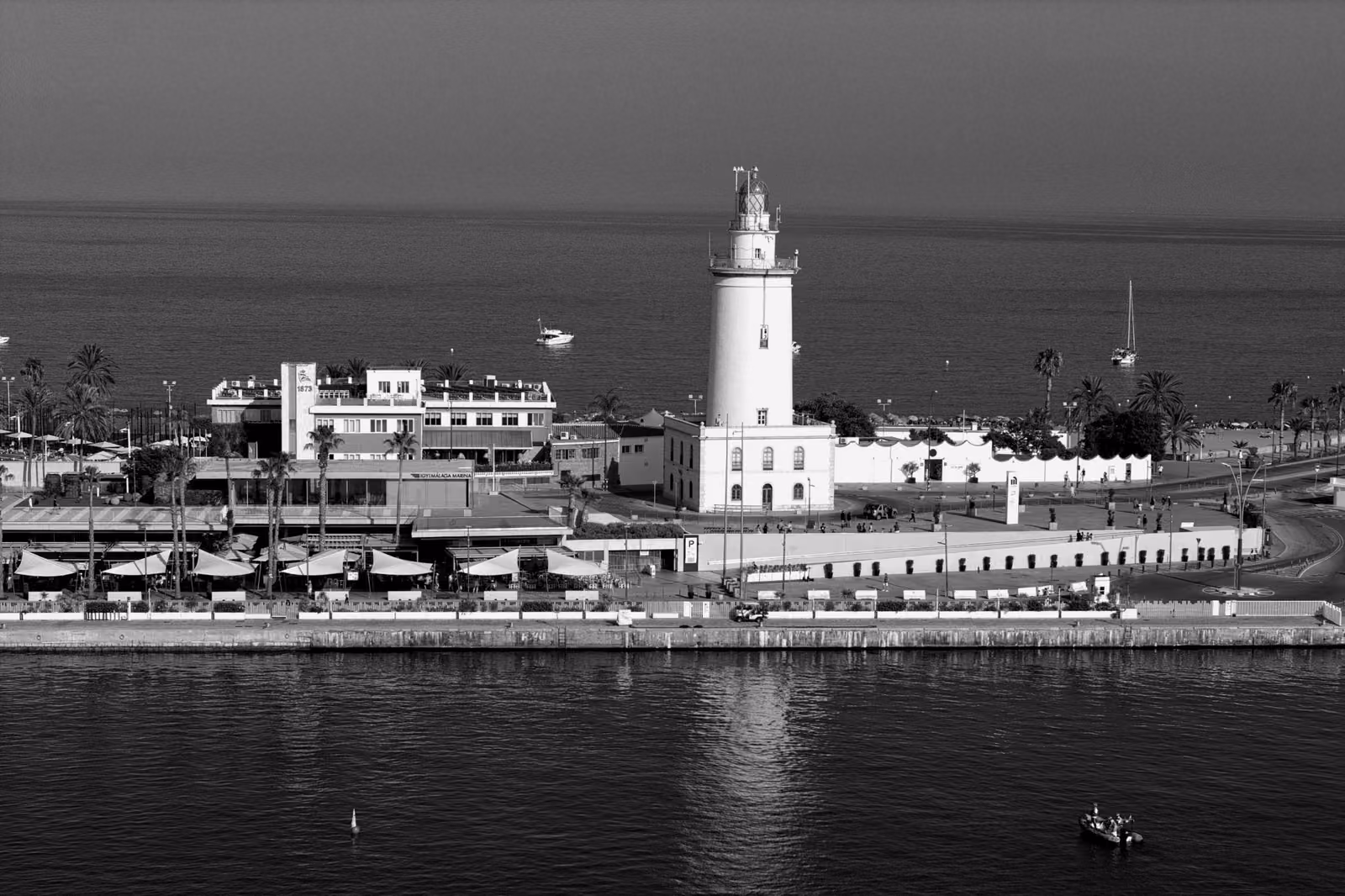 A wide view of the Malaga Lighthouse situated on the Mediterranean coast.