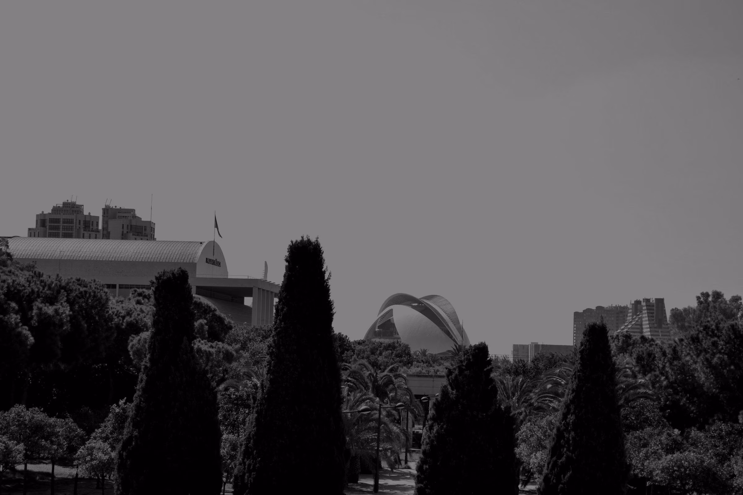 A view of the Turia Garden and a modern building in Valencia.