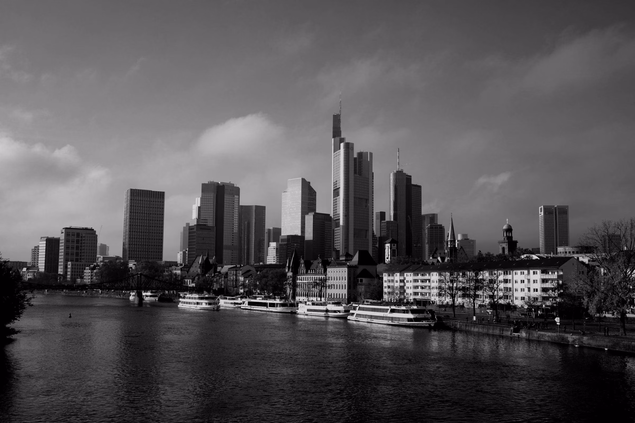 The Frankfurt am Main skyline above the river on a sunny day.